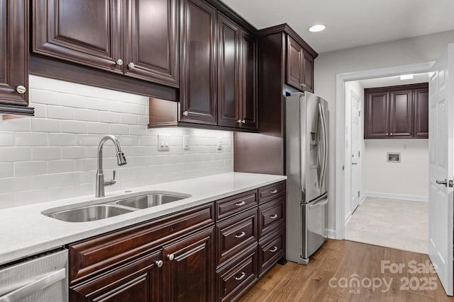 7502 Hurstbourne Green Dr, Charlotte, NC 28277 - kitchen featuring light countertops, wood finished floors, a sink, and stainless steel refrigerator with ice dispenser