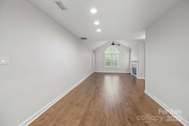 7502 Hurstbourne Green Dr, Charlotte, NC 28277 - unfurnished living room featuring a glass covered fireplace, visible vents, a ceiling fan, and wood finished floors