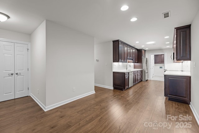 7502 Hurstbourne Green Dr, Charlotte, NC 28277 - kitchen featuring visible vents, a sink, light countertops, appliances with stainless steel finishes, and dark brown cabinets