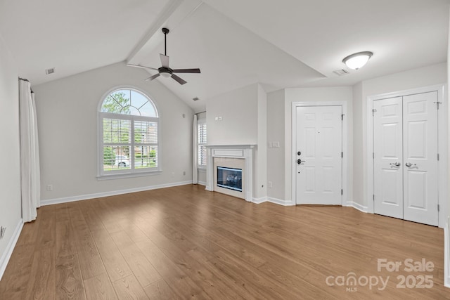 7502 Hurstbourne Green Dr, Charlotte, NC 28277 - unfurnished living room with a glass covered fireplace, baseboards, visible vents, ceiling fan, and wood finished floors