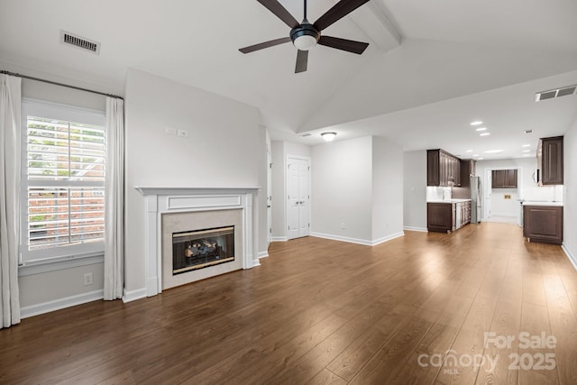 7502 Hurstbourne Green Dr, Charlotte, NC 28277 - unfurnished living room featuring dark wood-type flooring, visible vents, a ceiling fan, and a high end fireplace