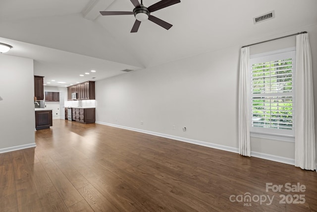 7502 Hurstbourne Green Dr, Charlotte, NC 28277 - unfurnished living room with dark wood-type flooring, visible vents, baseboards, and a ceiling fan