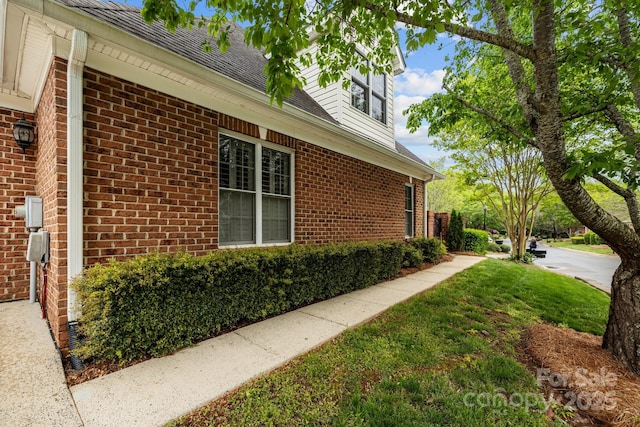 7502 Hurstbourne Green Dr, Charlotte, NC 28277 - view of property exterior featuring a shingled roof, a lawn, and brick siding