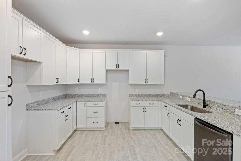 4175 River Run Cir, Hickory, NC 28602 - kitchen featuring stainless steel dishwasher, light wood-type flooring, white cabinetry, light stone counters, and a sink