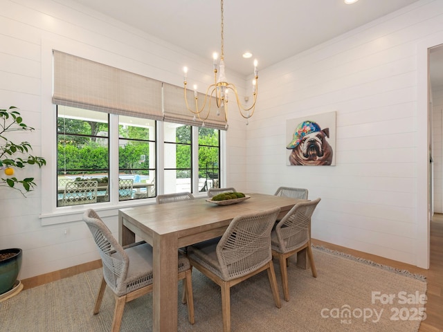 dining area with an inviting chandelier, recessed lighting, and wood finished floors