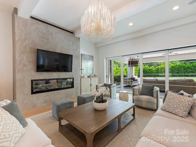 living room with recessed lighting, light wood finished floors, a notable chandelier, and a premium fireplace