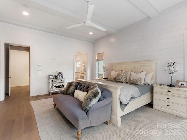 bedroom with a ceiling fan, light wood-type flooring, beam ceiling, connected bathroom, and recessed lighting