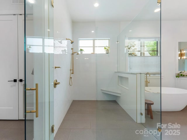 bathroom with tile patterned flooring, visible vents, a freestanding tub, tiled shower, and recessed lighting