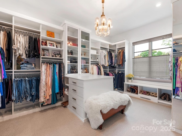 spacious closet featuring carpet floors and a chandelier
