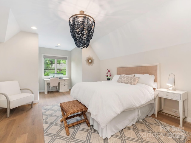 bedroom with a chandelier, light wood-style flooring, recessed lighting, baseboards, and vaulted ceiling