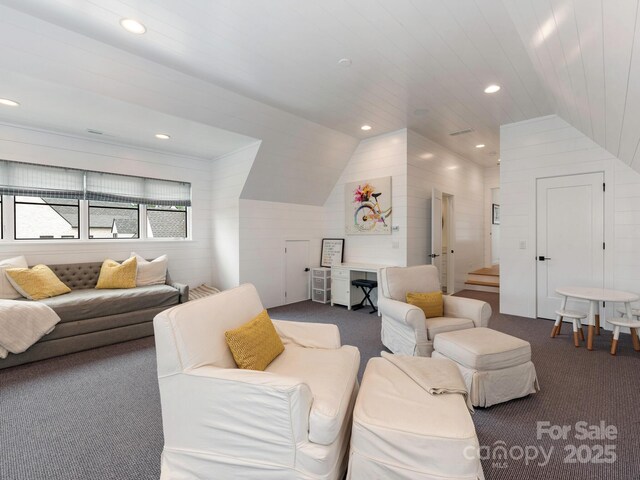 carpeted living area with recessed lighting and vaulted ceiling