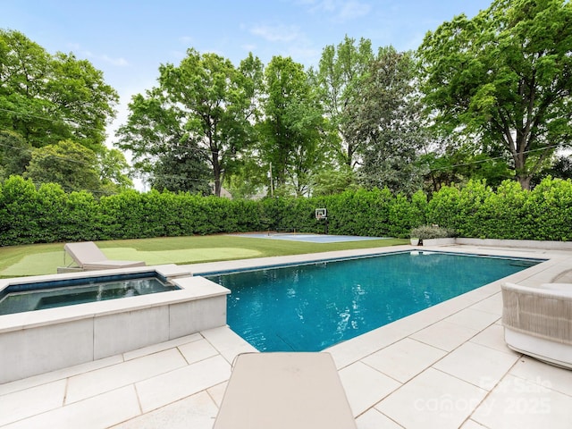 view of swimming pool with a patio, an in ground hot tub, and a fenced in pool