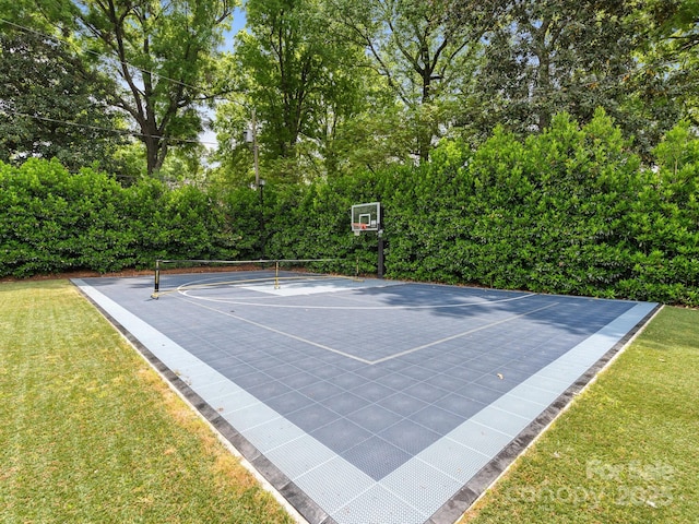 view of sport court with a lawn, basketball hoop, and a tennis court