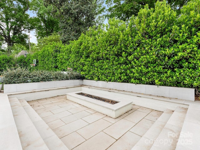 view of patio featuring an outdoor fire pit