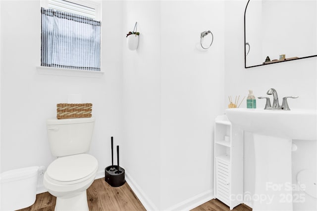 3153 Pinehills Way, Mount Holly, NC 28120 - half bath with a sink, baseboards, toilet, and wood finished floors