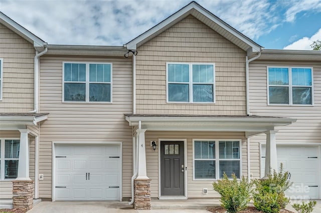 view of front facade with a garage, driveway, and a porch