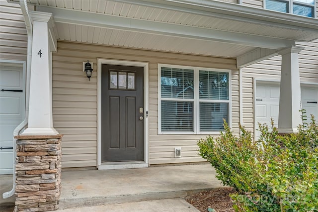 view of exterior entry with a porch