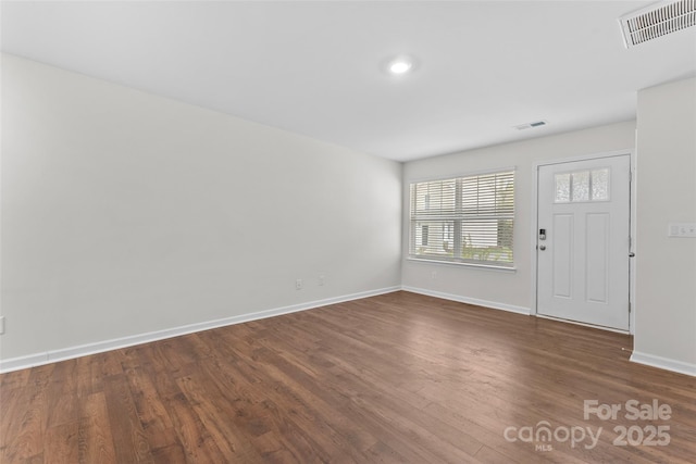 entryway with visible vents, baseboards, and dark wood-style flooring