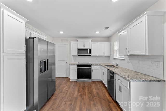 kitchen featuring white cabinetry, appliances with stainless steel finishes, a sink, and visible vents