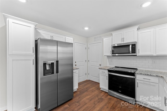kitchen featuring light stone counters, stainless steel appliances, white cabinets, visible vents, and recessed lighting