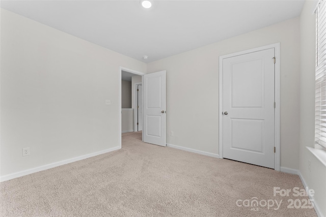 unfurnished bedroom featuring baseboards and carpet flooring