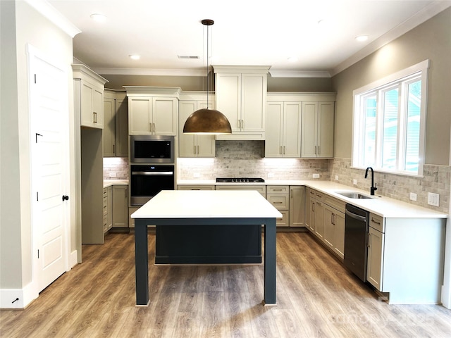 117 Blackbeard Ln, Mooresville, NC 28117 - kitchen featuring stainless steel appliances, light countertops, visible vents, ornamental molding, and a sink