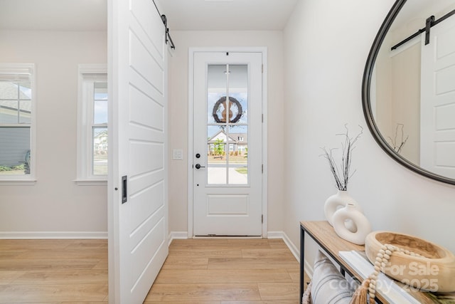 8011 Green Heron Ct, Belmont, NC 28012 - foyer entrance with a barn door, light wood-type flooring, and baseboards