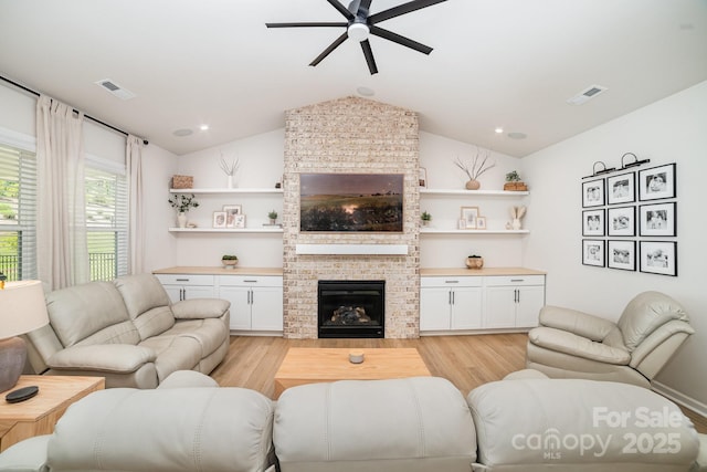 8011 Green Heron Ct, Belmont, NC 28012 - living room with a ceiling fan, light wood-style flooring, a fireplace, and vaulted ceiling