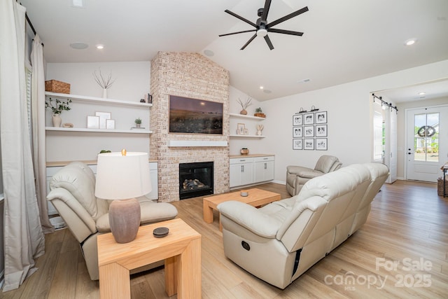 8011 Green Heron Ct, Belmont, NC 28012 - living area featuring a ceiling fan, light wood finished floors, lofted ceiling, and a fireplace