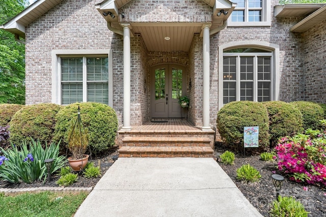 doorway to property with brick siding and french doors