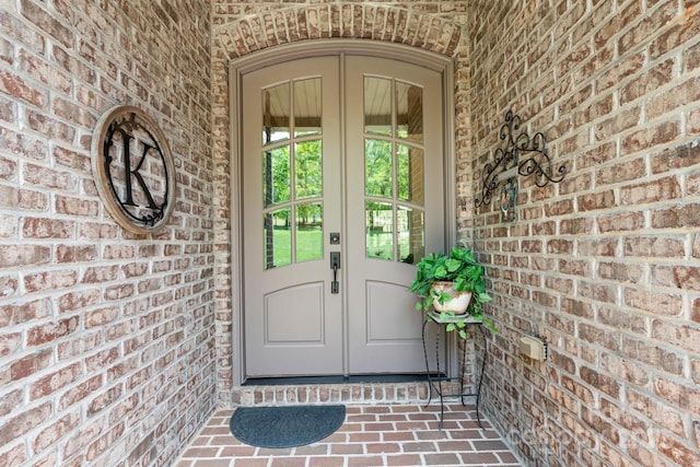 doorway to property with brick siding and french doors
