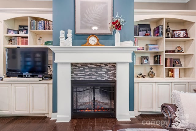 interior space featuring dark wood finished floors and a tiled fireplace