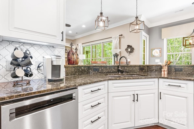 kitchen featuring dishwasher, a wealth of natural light, white cabinetry, and a sink