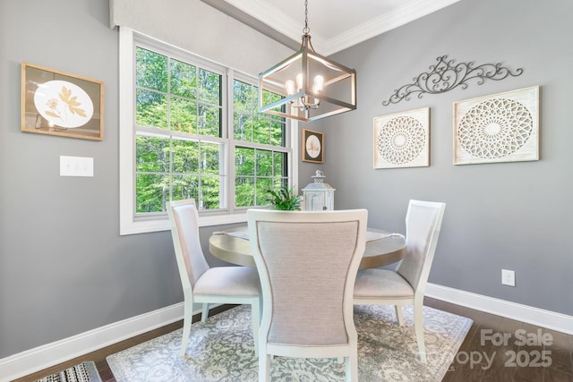 dining area featuring ornamental molding, baseboards, a notable chandelier, and a healthy amount of sunlight