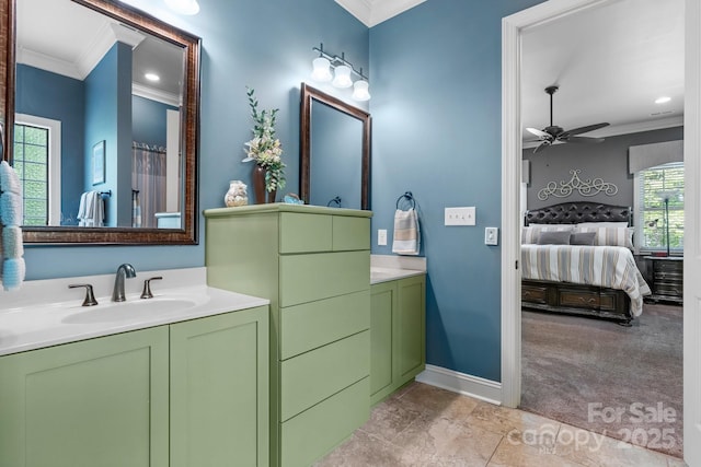 ensuite bathroom featuring ceiling fan, baseboards, ornamental molding, and ensuite bathroom