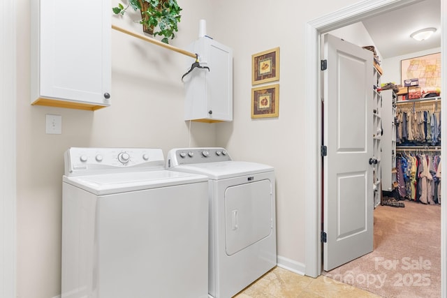 laundry room with cabinet space, independent washer and dryer, baseboards, and light colored carpet