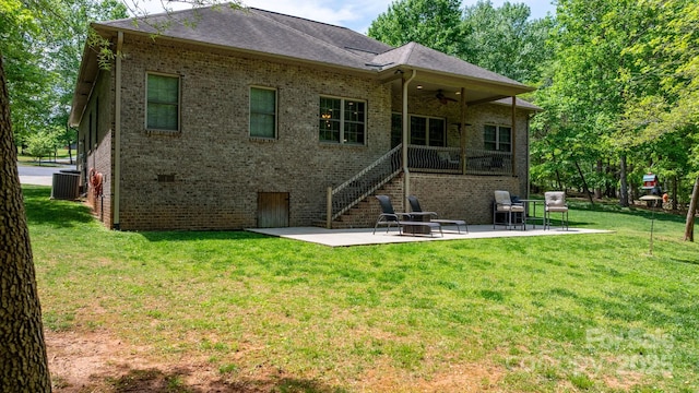 back of property with brick siding, a ceiling fan, central AC, and a patio