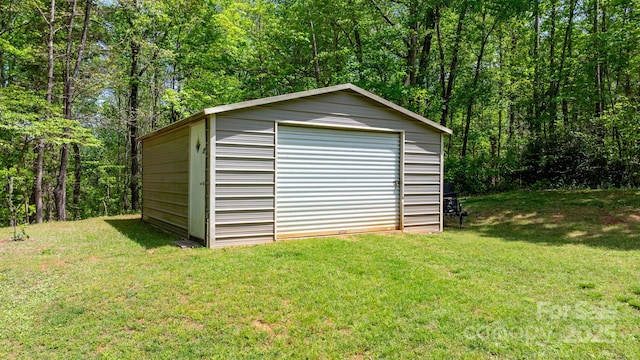 view of outdoor structure featuring a forest view and an outdoor structure