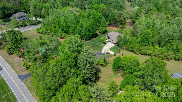 birds eye view of property with a wooded view