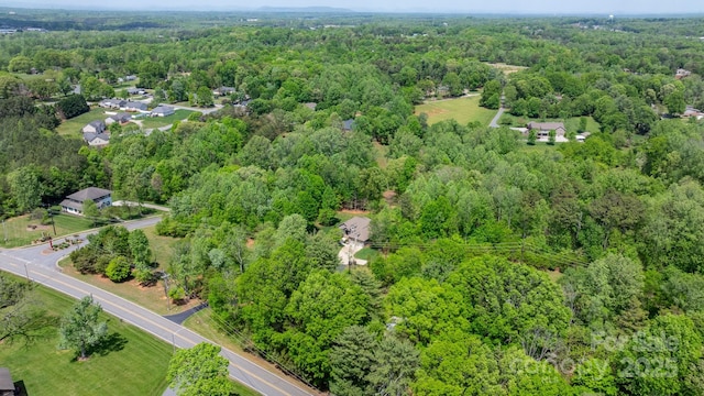 birds eye view of property with a view of trees