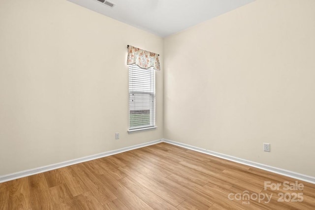 20135 Dovekie Ln, Fort Mill, SC 29707 - empty room with light wood finished floors, visible vents, and baseboards