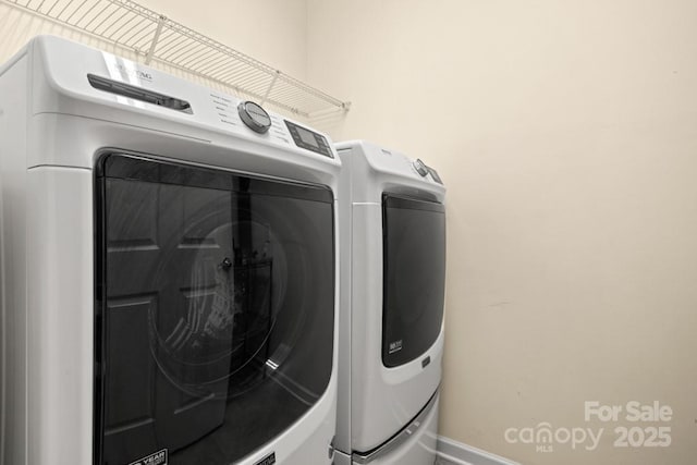 20135 Dovekie Ln, Fort Mill, SC 29707 - clothes washing area featuring washing machine and clothes dryer, laundry area, and baseboards