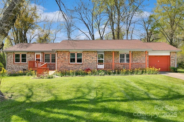 single story home with an attached garage, brick siding, a front yard, and concrete driveway