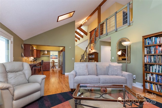 22 Robinhood Rd, Asheville, NC 28804 - living room with stairway, baseboards, high vaulted ceiling, and wood finished floors