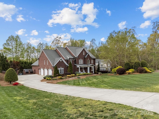 view of front of home featuring a garage, a front yard, and concrete driveway