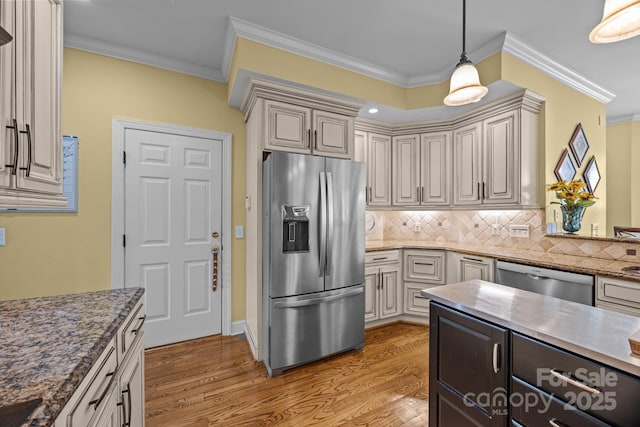 kitchen with tasteful backsplash, light wood-style flooring, crown molding, decorative light fixtures, and stainless steel appliances