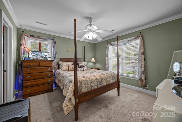 carpeted bedroom with visible vents, baseboards, crown molding, and a ceiling fan