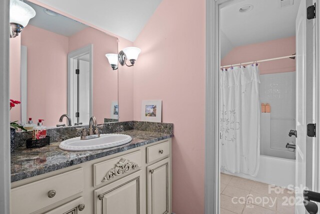 bathroom with shower / bath combo, tile patterned floors, and vanity