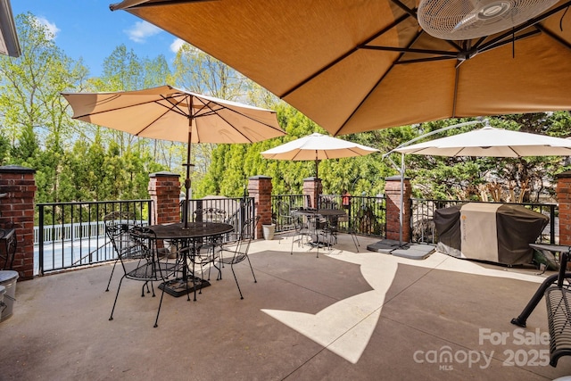 view of patio featuring outdoor dining space and a grill