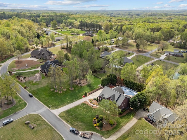 drone / aerial view featuring a forest view